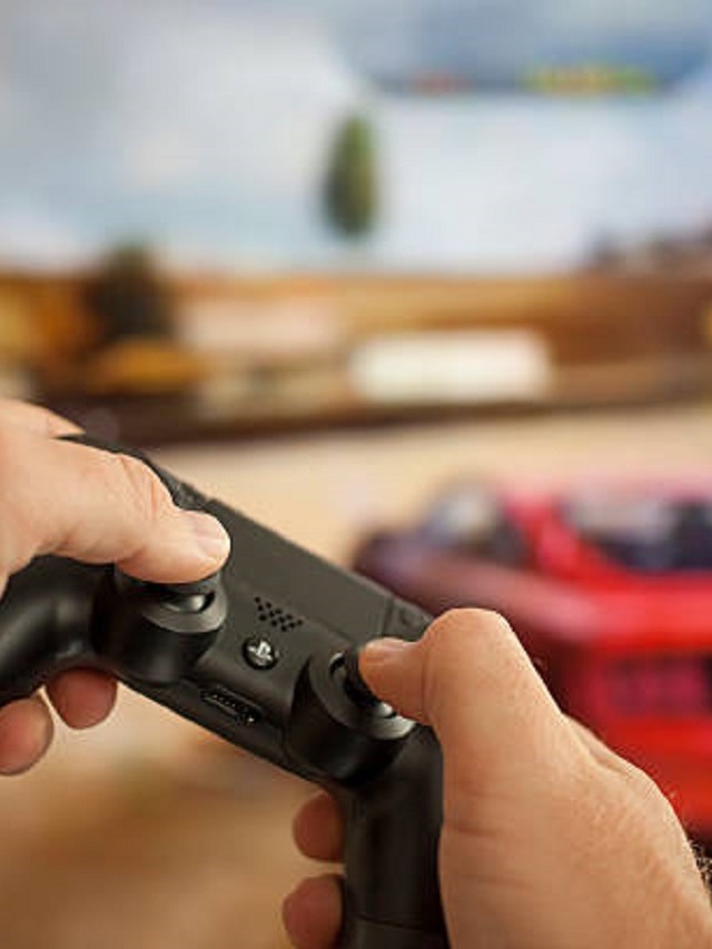 Capa melhores jogos de corrida para PS4 com alguém segurando um controle na frente de uma TV com um jogo de carro atrás