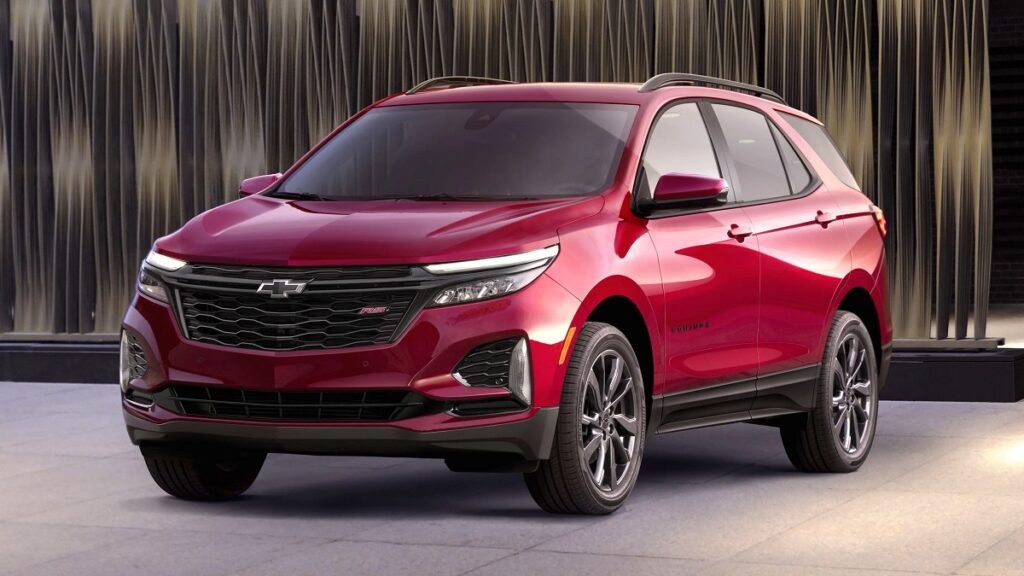 Lateral frontal Equinox 2023 versao esportiva de cor vermelha em uma garagem