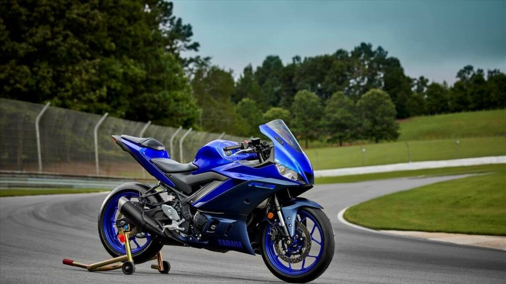 Foto lateral de um R3 2023 azul estacionada em uma pista