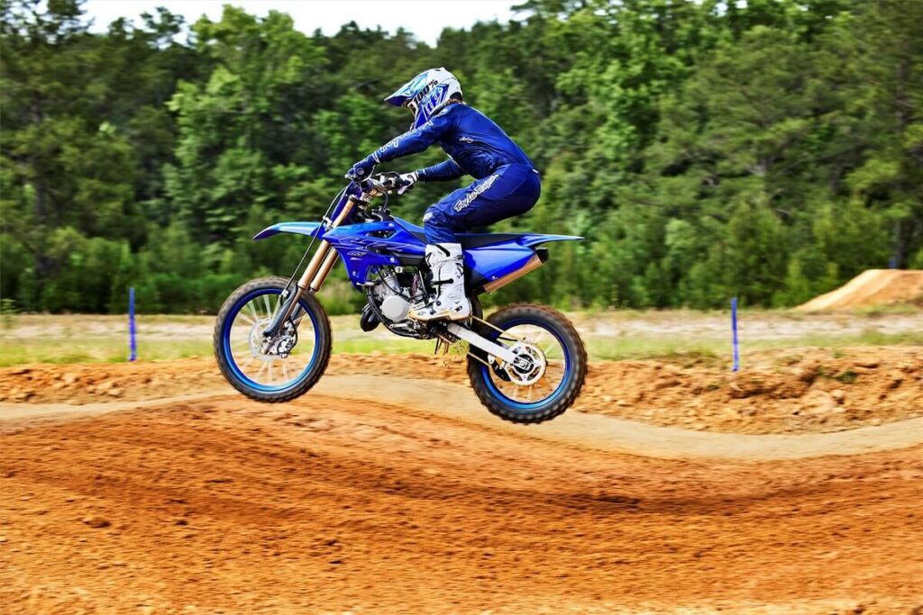 Foto de uma pessoa saltando com uma YZ 85 LW 2023 azul