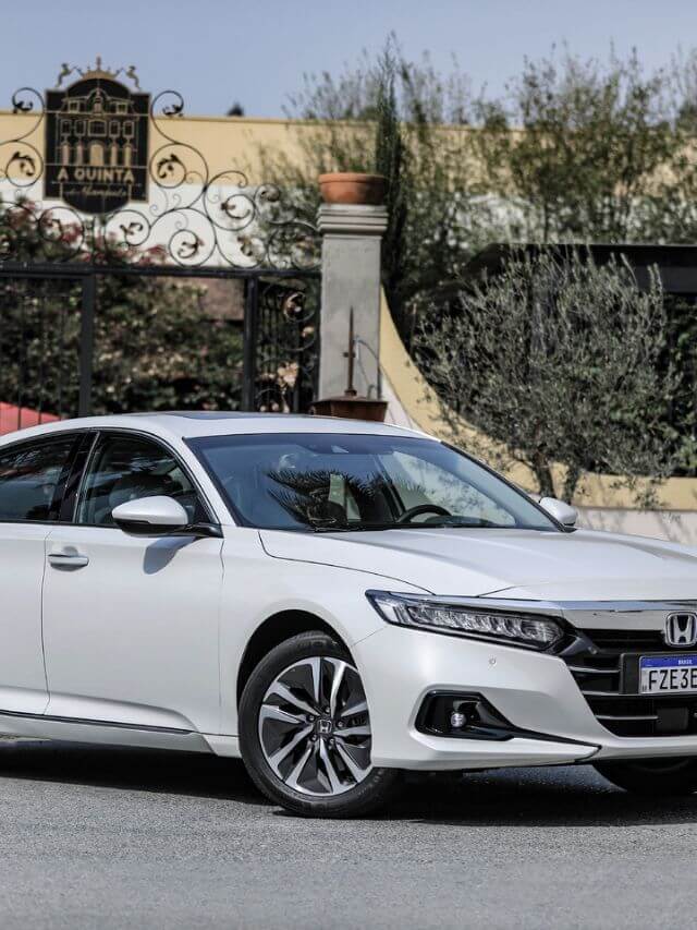 Honda Accord 2023 branco, parado na frente de um portão.
