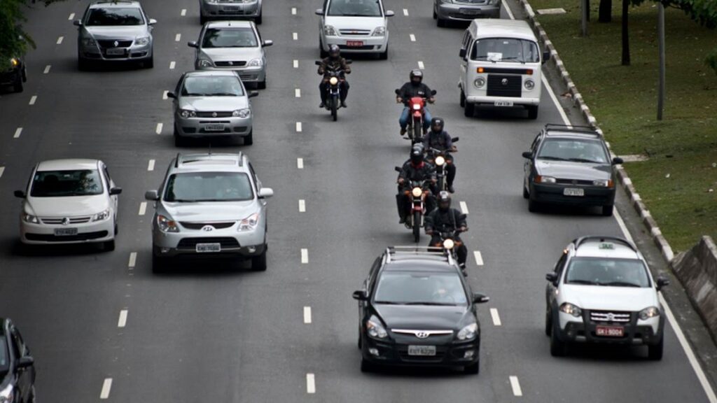 Foto de vários carros andando em uma estrada