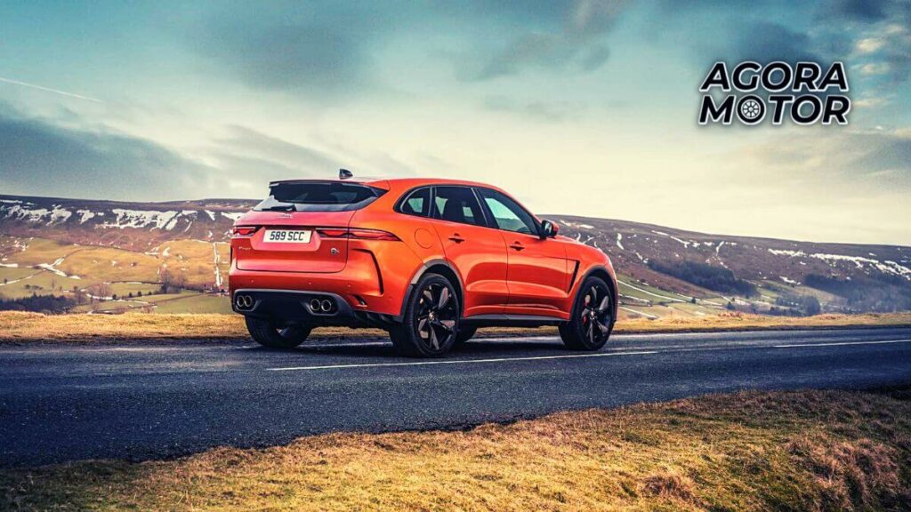 Foto traseira de um F-Pace 2023, andando em uma estrada