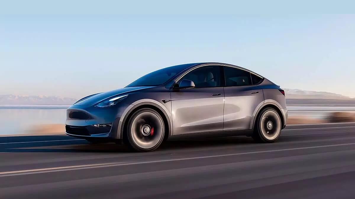 Foto de um Tesla Model Y 2023 andando em uma estrada