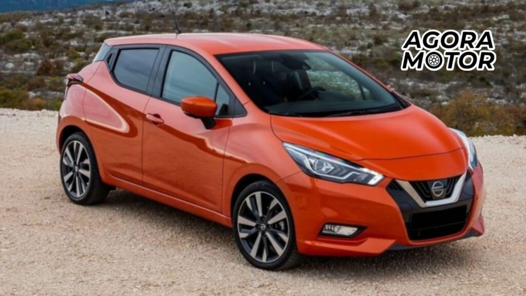 Foto de um March laranja em terra de pedras com arbustos ao fundo