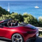 Ferrari vermelha na estrada perto do mar.