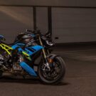 bmw s 1000 r azul com detalhes em amarelo e preto estacionada em um estacionamento