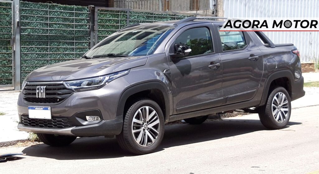 Fiat Strada cinza parada na diagonal.