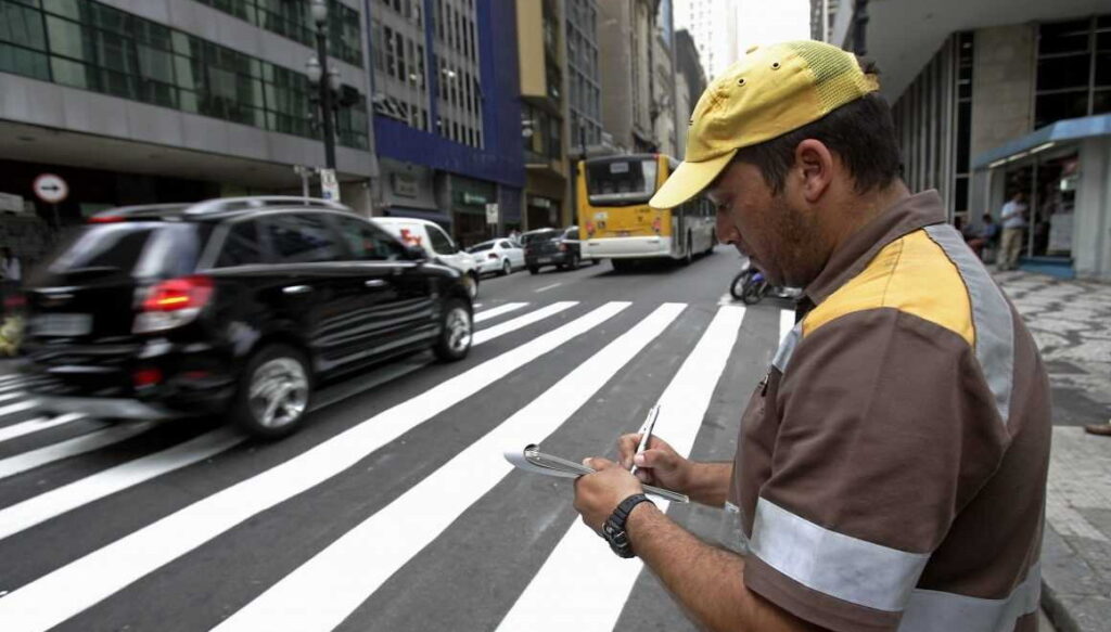 Homem dando multas de trânsito.