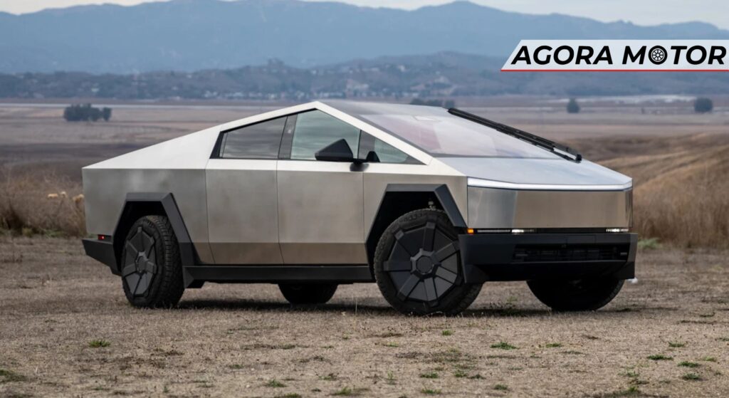 Carro da tesla prata parado de lado.