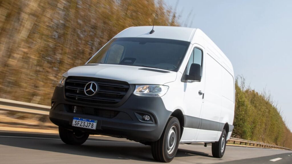 Van branca andando na estrada.