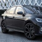 Lateral do Volkswagen Virtus exclusive preto parado na diagonal.