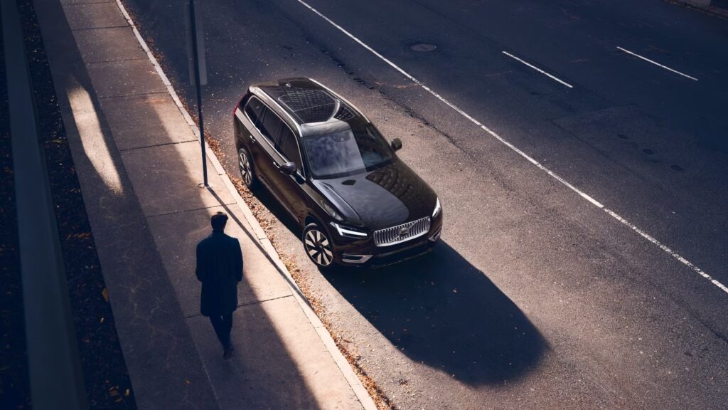 Volvo XC90 híbrido Plug-in preto parado na estrada.