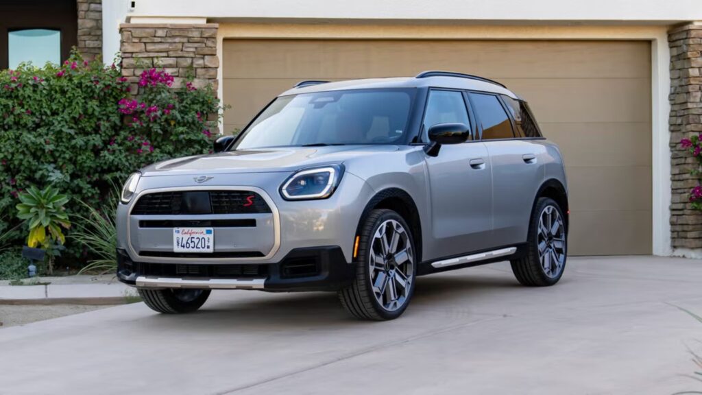 Mini Countryman 2026 cinza parado na diagonal em frente de uma garagem.