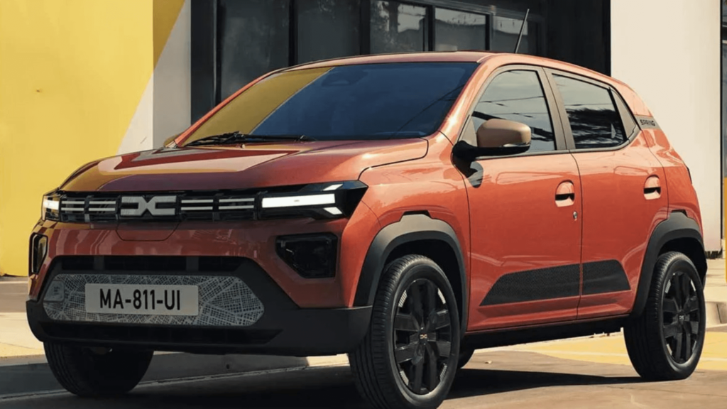 Novo Kwid E-Tech laranja parado na beirada da estrada.