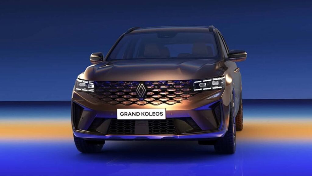 Frente do Renault Grand Koleos marrom no fundo escuro.